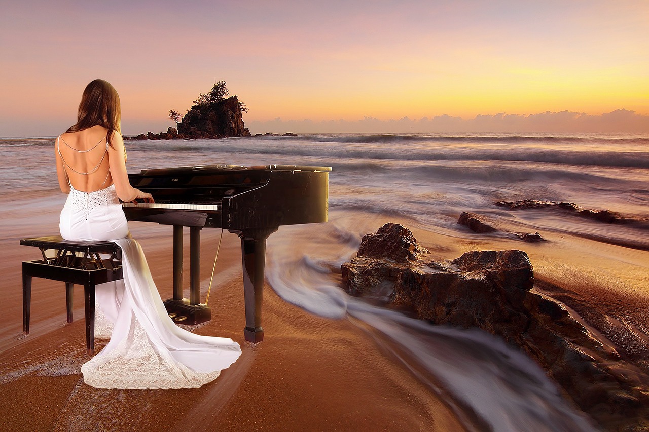 Girl playing piano on the beach